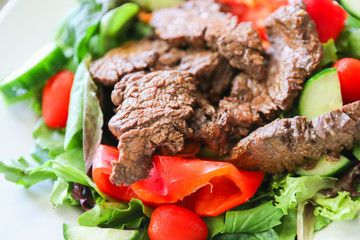 Delicious juicy barbequed steak, grilled meat  beef ( lamb ) garnished with tomatoes ,tomatoes and vegetables