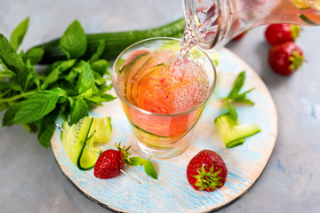 Non alcoholic summer cocktail with soda, strawberry and cucmber