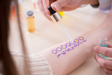 Doctor testing allergy reaction of patient in hospital