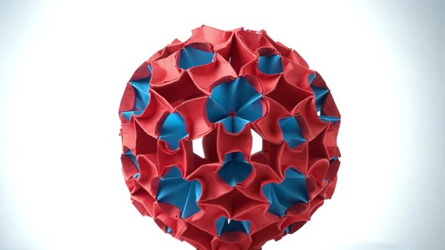 Exhibition of origami ball. Red and blue origami unit flowers isolated on white background.