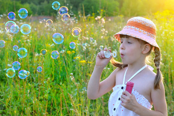 child, kid, plays with bubbles on nature