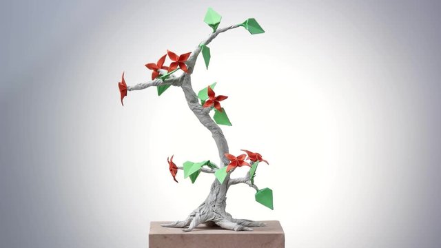 Paper origami plant. Origami exposition in white background.