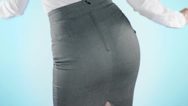 Beautiful business woman on a colored background. close-up skirt. dress code, move the hips. 4k, slow motion