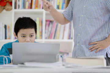 Preteen student rebuked by his teacher in library