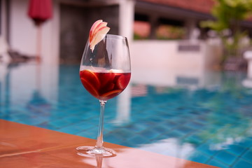 Red wine sangrai at poolside bar