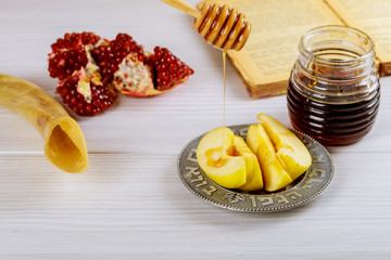 rosh hashanah jewesh holiday concept shofar, torah book, honey, apple and pomegranate. traditional holiday symbols.