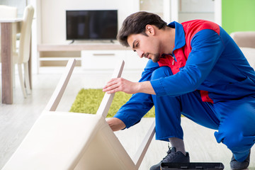 Repair contractor repairing broken chair at home