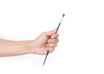 hand holding a paintbrush on white background.