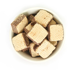 wafer chocolate in bowl top view on white background