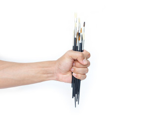 hand holding a paintbrush on white background.