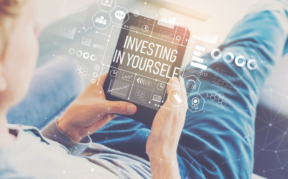 Investing in yourself with man using a tablet in a chair