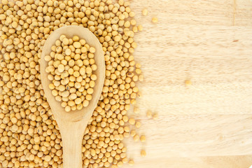 soy bean on wooden spoon on wooden table.