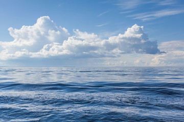 Obraz premium Cumulus white clouds over the water surface of Ladoga Lake. Karelia. 