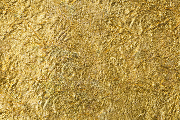 Crumpled golden tin foil texture background