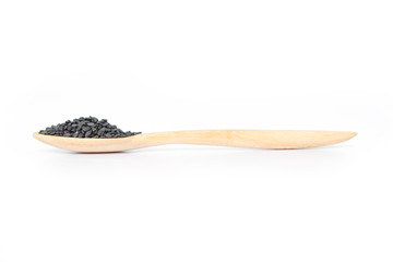 Heap of black sesame on wooden spoon on white background.
