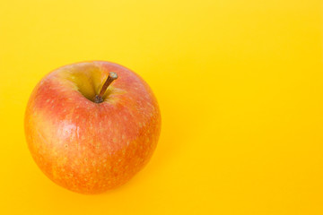 red apple on yellow background