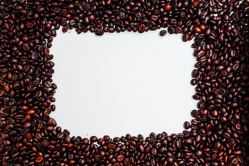 Roasted coffee beans isolated on white with copy space for text