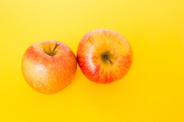red apple on yellow background