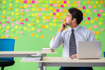 Man in the office with many conflicting priorities doing exercis