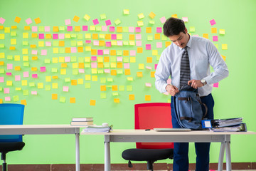Man in the office with many conflicting priorities