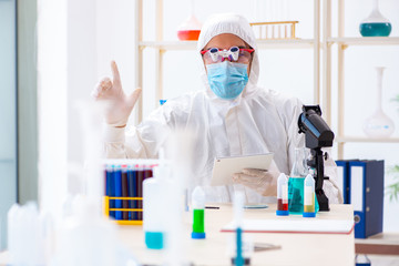 Young chemist student working in lab on chemicals