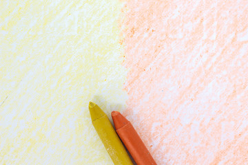 yellow and orange crayon drawings on white paper background texture