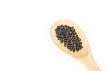 peppercorns in spoon heap on white background.