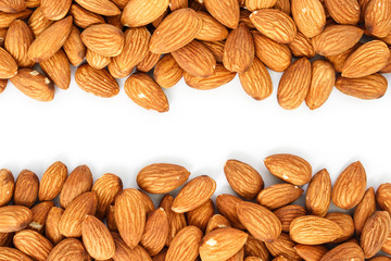 heap almonds top view frame or border on white background.