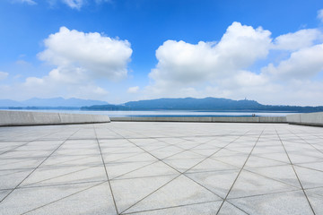 Empty square floor and mountain scenery under the blue sky