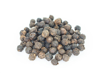 black peppercorns heap on white background.