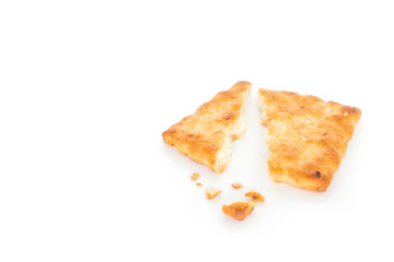 single cracker square broken on white background.