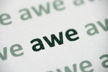 word awe  printed on paper macro