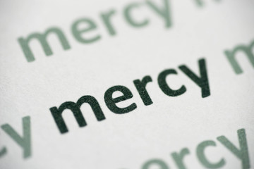 word mercy printed on paper macro