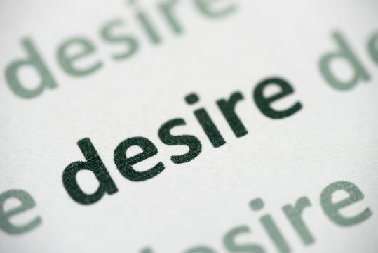 word desire printed on paper macro