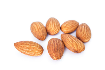 heap almonds on white background.