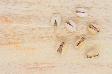 heap pistachio on wooden background.