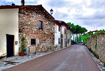 Village street in the province of Tuscany Italy. In the style of Impressionism