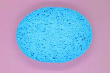 Abstract composition of blue sponge on pink background surface