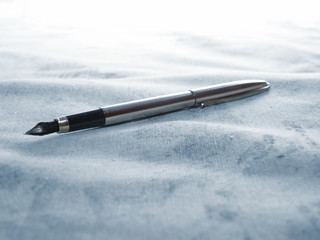 the fountain pen is on the fabric