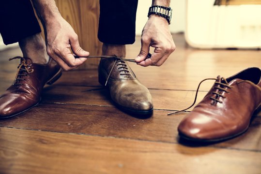 Man Tying Up His Shoes