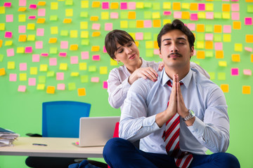Man and woman in the office with many conflicting priorities in 