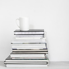 Cup of coffee on stack of books