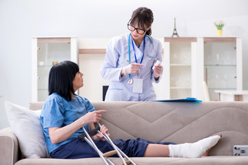 Fototapeta premium Doctor examining old mature woman after incident