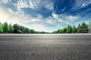 Tuinposter Asphalt road and green forest landscape under the blue sky © ABCDstock