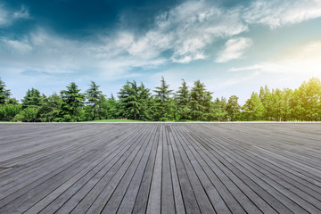 Wood square floor and green trees natural landscape