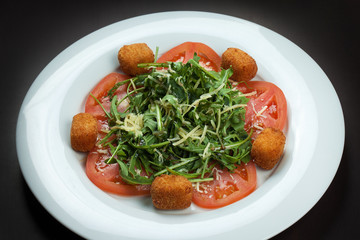 Cheese balls with tomatoes and parsley