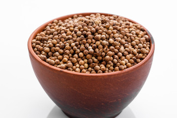 fragrant coriander seeds on a white background