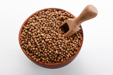 fragrant coriander seeds on a white background