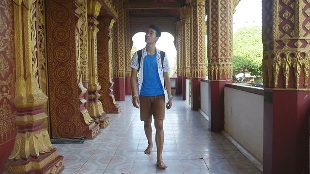 Asian Man Walking In Temple