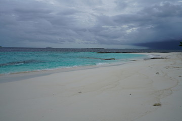 View of the beautiful beach with turquoise colored water during monsoon season in The Maldives